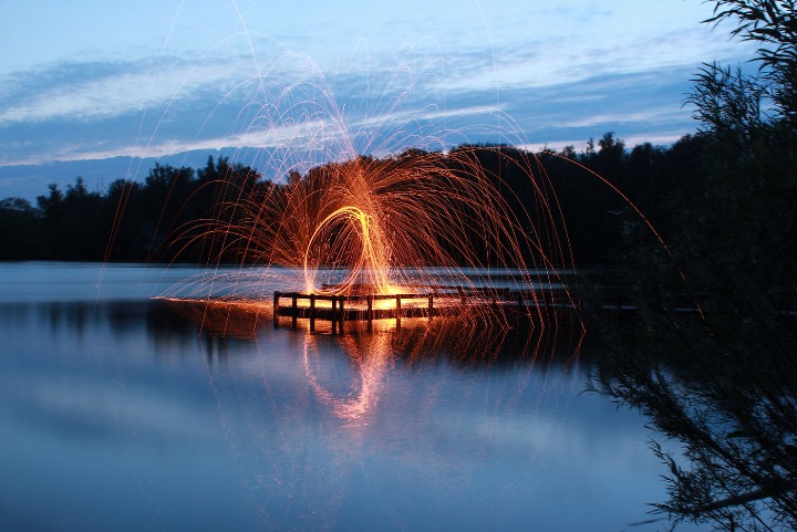 Long-exposure light loop over still water
